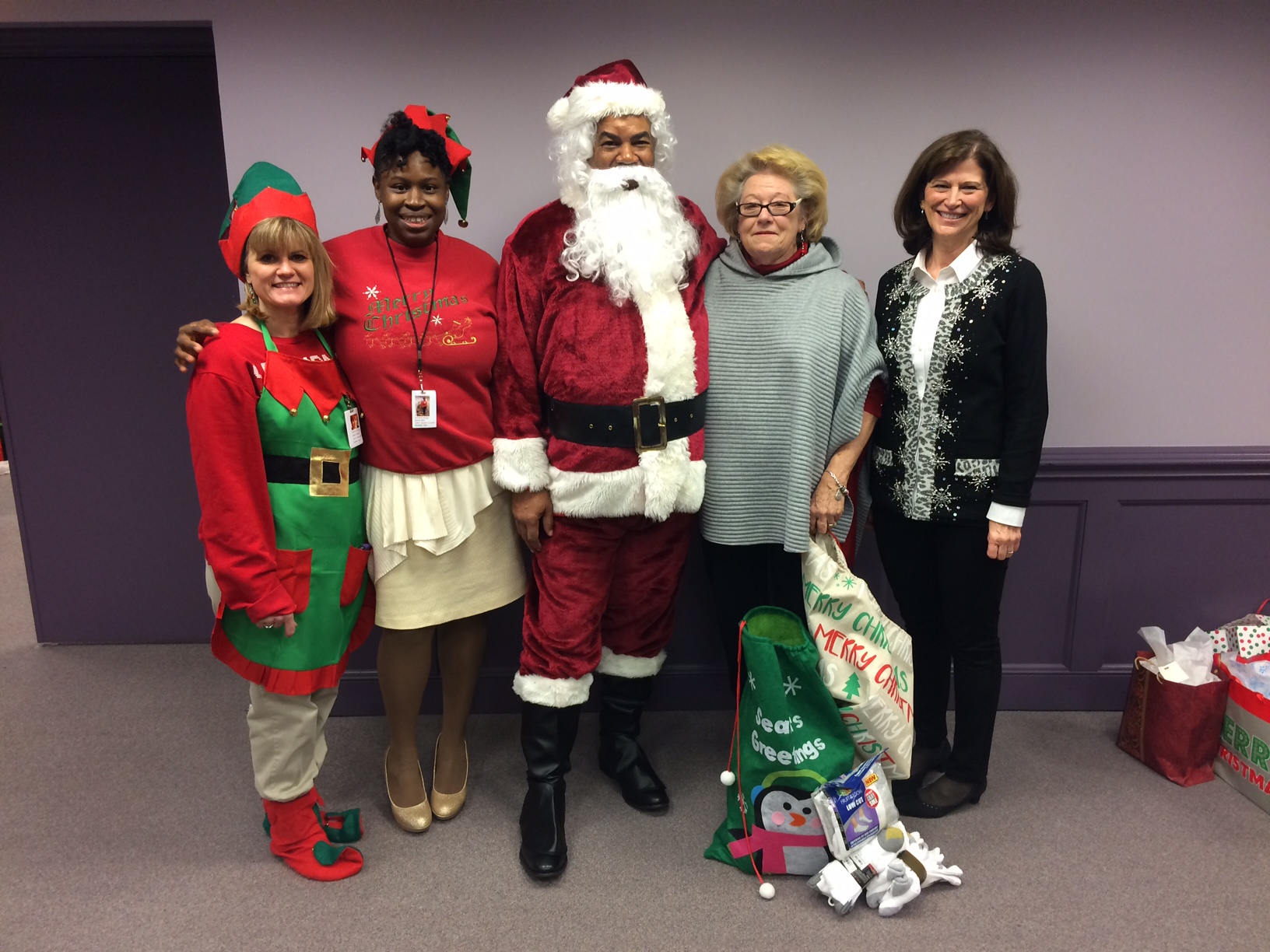 Man dressed as santa with staff members and socks
