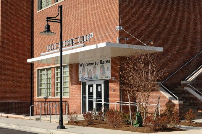 Entrance of a brick building with a sign reading 