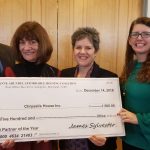 Four smiling people in business attire hold a large ceremonial check made out to Chrysalis House Inc. for $1,500 from the Anne Arundel Affordable Housing Coalition, dated December 14, 2018, for Non-Profit Partner of the Year.