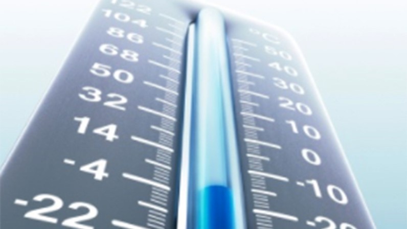 Close-up of a thermometer showing temperatures in both positive and negative Celsius, with the indicator bar filled to a point below zero. The image has a cool, blue-toned color scheme.